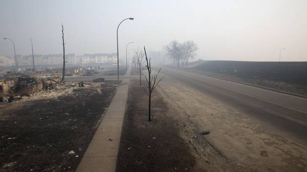 Gutted homes and smoky streets in the Beacon Hill neighborhood of Fort McMurray.