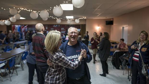 Appleton mayor Derm Flynn, one of the Newfoundlanders portrayed in Come From Away, laughs as he dances with cast member Kendra Kassebaum at an after-show celebration on Oct. 30.