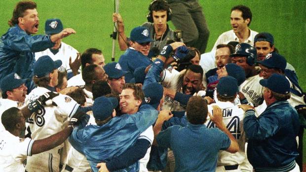 Joe Carter is mobbed by teammates after his game-winning home run in the bottom of the 9th inning in game 6 of World Series on Oct. 23, 1993.
