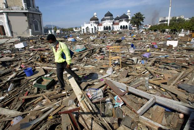 A man walks through debris near the Great Mosque in Banda Aceh, Indonesia, on Dec. 29, 2004.