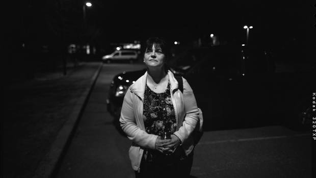 Trish Madigan, 44, is photographed in the parking lot of a seniors residence where she's about to begin her second shift of the day at 11 p.m.