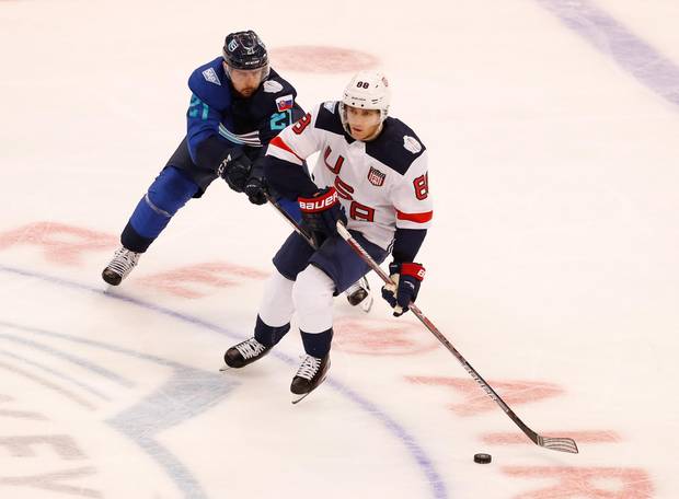 Patrick Kane of Team USA tries to control the puck next to Tomas Tatar of Team Europe at the World Cup of Hockey on September 17, 2016 in Toronto, Canada.