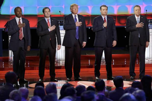 The five Republican presidential candidates listen to the U.S. naitonal anthem before a televised debate in February.