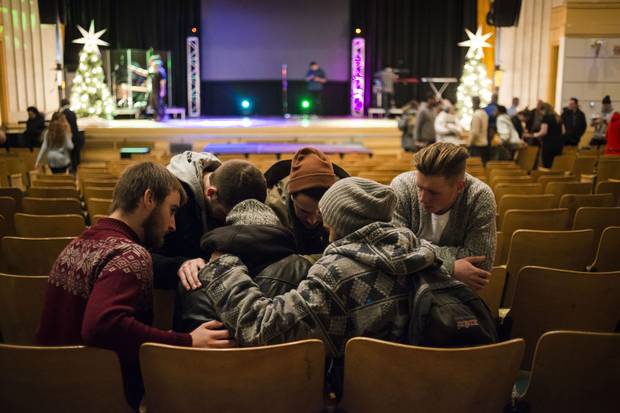 A group of young people pray together after a Christian City Church service in Toronto last month. The C3 Pentecostal movement, which originated in Australia, has spread to more than 450 churches around the world, including 11 congregations across Canada.