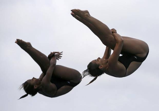 Canada's Jennifer Abel and Pamela Ware perform a dive at the women's synchronized 3-meter springboard final during the World Swimming Championships in Barcelona, Spain, in July 2013.