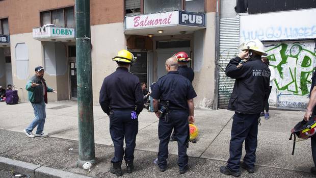 Vancouver firefighters gather outside the Balmoral Hotel.