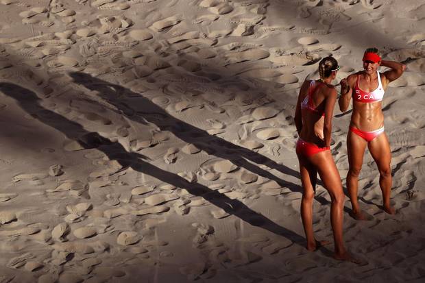 Heather Bansley of Canada, right, and teammate Sarah Pavan look on during a women's quarterfinal match between Canada and Germany on Day 9 of the Rio 2016 Olympic Games at the Beach Volleyball Arena on August 14, 2016 in Rio de Janeiro, Brazil.
