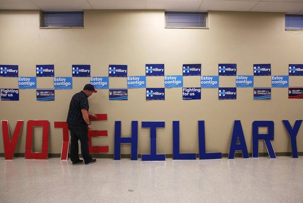 Martin Casas, Democratic presidential candidate Hillary Clinton campaign state outreach director of St. Louis, fixes the letters of a sign that reads 