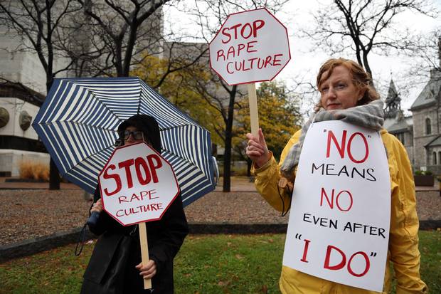 Alice Dean, left, and Ruth Greer demonstrate against rape culture in front of an Ontario courthouse.