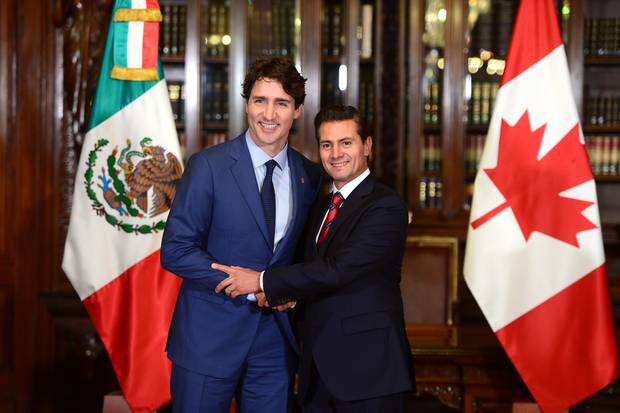 Canadian Prime Minister Justin Trudeau, left, and Mexican President Enrique Pena Nieto shakes hands during a meeting at the Palacio Nacional in Mexico City on Oct. 12, 2017.