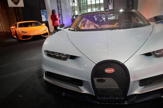 A Bugatti and Lamborghini are displayed alongside other exotic sports cars outside the press center at the North American International Auto Show (NAIAS) on January 14, 2018 in Detroit, Michigan.