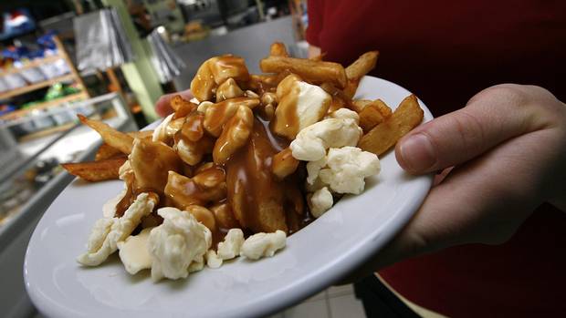 A serving of poutine heads out to a customer at La Formagerie du Village in Warwick, Que.
