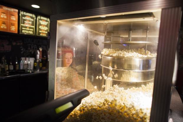 Sadie Vandnais works the popcorn machine at the Rio Theatre.