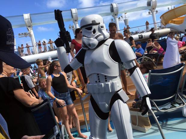 Stormtroopers patrol near Mickey Mouse-shaped pools as activities and games keep guests fully immersed in the Star Wars theme.