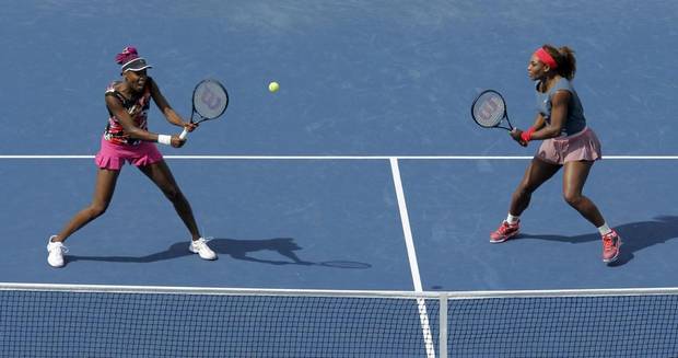 Venus Williams, left, and sister Serena during doubles play at the 2013 U.S. Open.