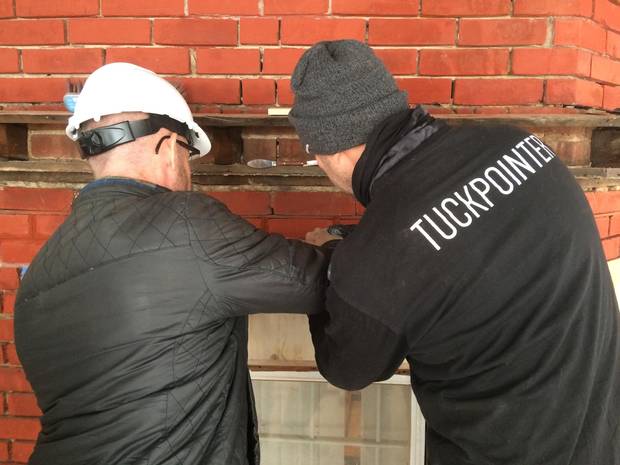 Melbourne-based master tuckpointer Antoni Pijaca instructs a student on the fine art of tuckpointing.