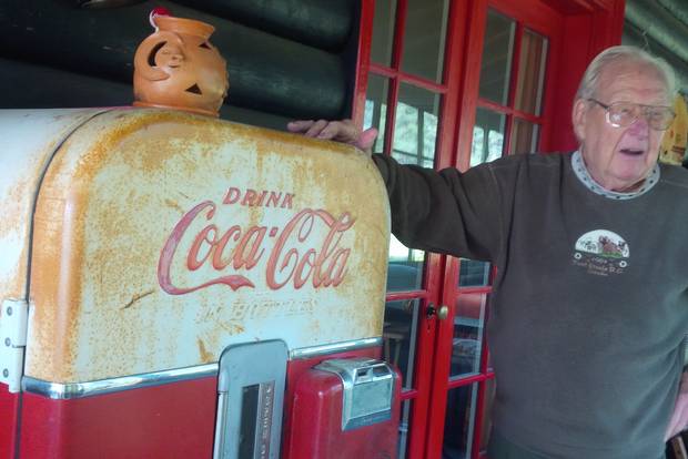 Bob Termuende on the porch next to a working Coke fridge from his wife's father's business. It's now a beer fridge.