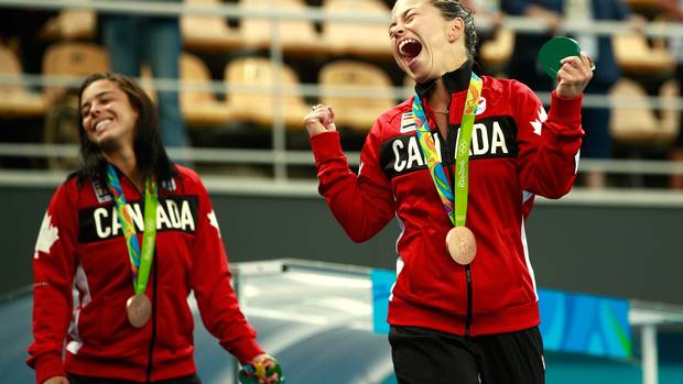 Roseline Filion (CAN) and Meaghan Benfeito (CAN) of Canada celebrate with their bronze medals.
