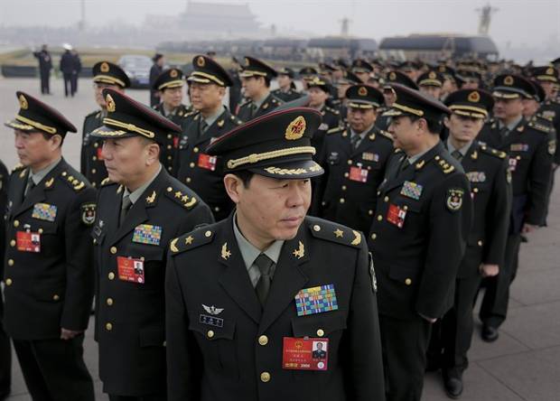 Delegates from China's People's Liberation Army arrive at the Great Hall of the People to attend a session of National People's Congress in Beijing on March 4, 2016.