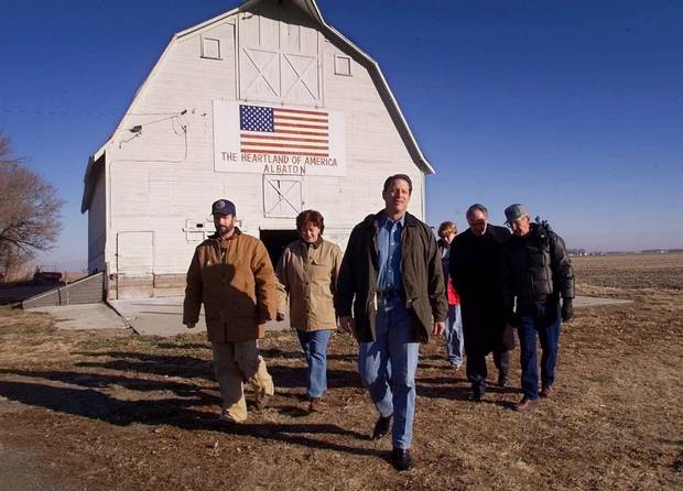 Al Gore walks out of a barn with members of the Roarson and Wilts families as he tours their farm in Sloan City, Iowa, on Jan. 13, 2000.