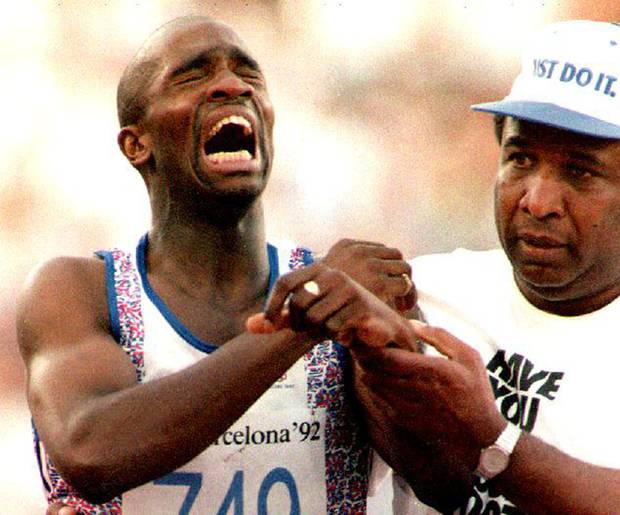 Derek Redmond of Great Britain is helped by an unidentified person in Barcelona, Spain after suffering an injury during a second round heat of the men’s 400-metre run at the 1992 Summer Olympics. 