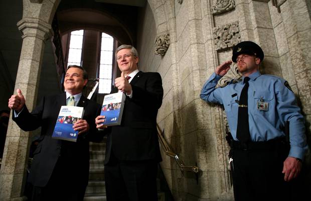 Former finance minister Jim Flaherty, left, and former prime minister Stephen Harper give a thumbs up as they walk to the House of Commons to deliver the budget on Parliament Hill in March, 2012.