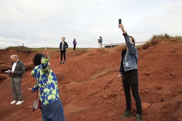 Cavendish, PEI: Ian Brown, left, takes notes as the travellers enjoy the red sandy vistas of Cavendish Beach.