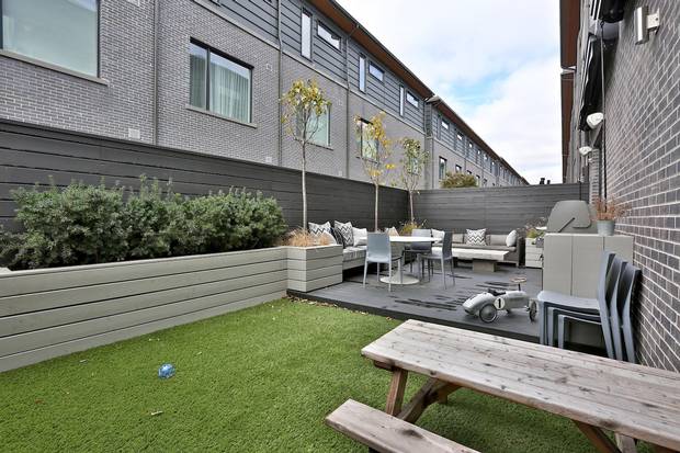 The backyard features artificial turf.