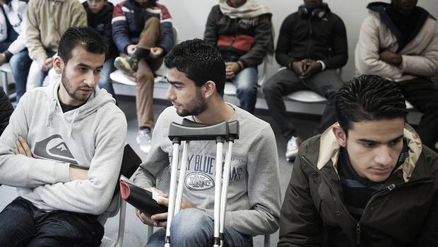Basel Omran, Osama Omran and Zain Al Abedin Omran nervously await the initial interview in their asylum process.