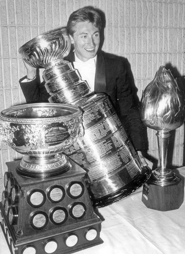 June 4, 1984. Edmonton Oiler hockey player Wayne Gretzky poses at last night's NHL awards dinner with some hardware he won for the past season.