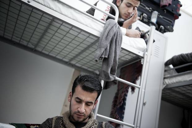 Zain Al Abedin Omran, above, and Basel Omran, below, in their room in the refugee camp at Neubiberg in Munich.