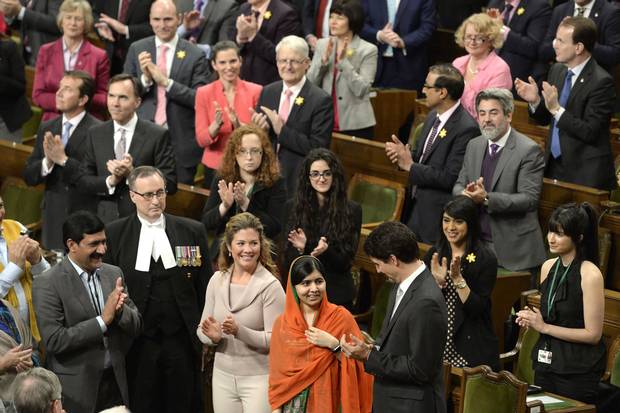 Prime Minister Justin Trudeau, right, and his wife Sophie Grégoire-Trudeau, centre left, clap as Pakistani activist and Nobel Peace Prize winner Malala Yousafzai, centre, is paid tribute in the House of Commons on April 12, 2017.
