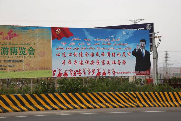 A billboard in China’s western Xinjiang urges people to ‘build an example of ethnic integration.’