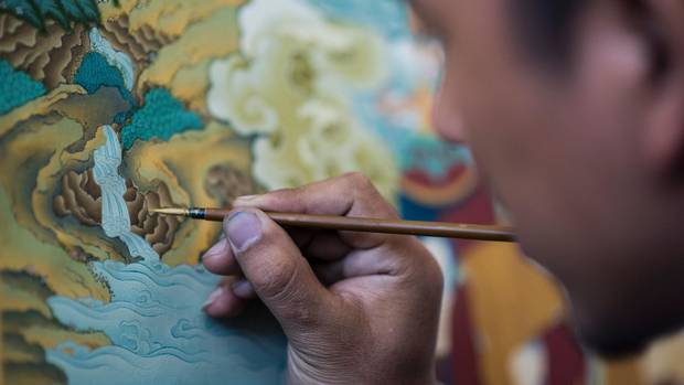 A student paints an example of the medieval Tibetan art of thangka on Sept. 10 at the Danba Raodan art school in Lhasa.