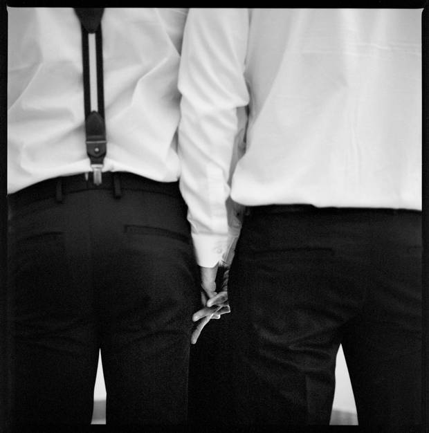 Andres Giminez and Carlos Ramo hold hands during their wedding ceremony.