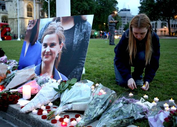 A mourner pays tribute to slain Labour MP Jo Cox at a vigil in Parliament square in London on June 16, 2016.