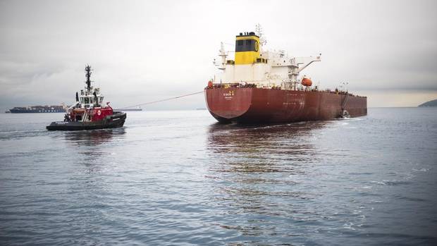 A SeaSpan tugboat escorts an oil tanker carrying oil from the Kinder Morgan pipeline.
