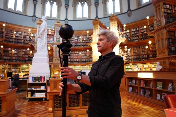 Carleton University professor Stephen Fai adjusts a 360-degree camera in the Library of Parliament.