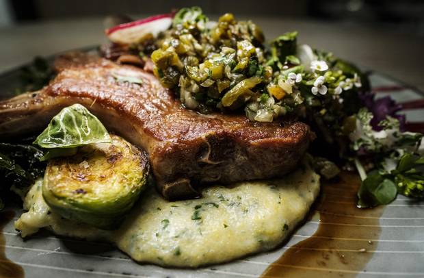Pork chop with cheesy polenta and Brussels sprouts.