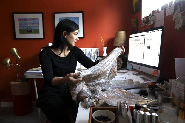 In Edmonton, Jana Pruden researches newspaper articles printed on a scarf from China.