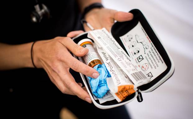 Hirsh holds a Naloxone injection kit during a overdose awareness program.