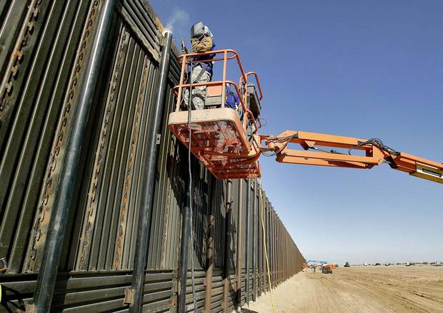 National Guardsmen weld a section of wall being erected along the international border that separates San Luis, Mexico, and San Luis, Arizona, in 2007.