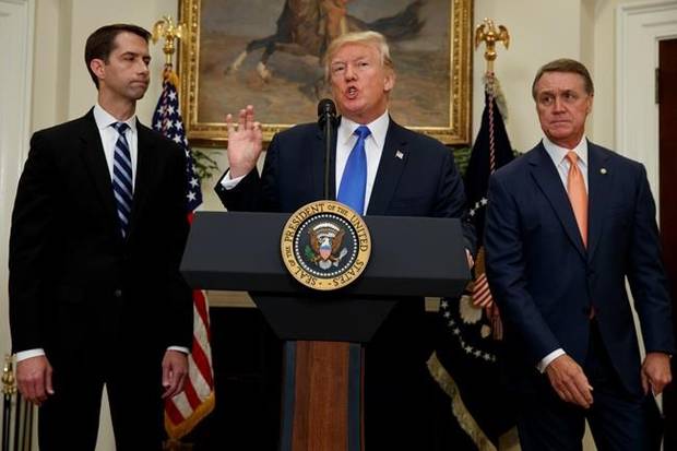 President Donald Trump, flanked by Sen. Tom Cotton and Sen. David Perdue speaks during the unveiling of legislation that would place new limits on legal immigration on Aug. 2.