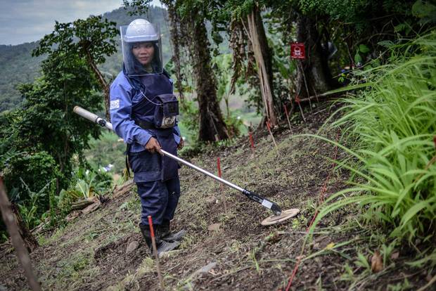 Sok Kanthy, 27, has been working as a deminer with the HALO Trust for two months. She uses an Ebinger GC tool to detect mines hidden in the ground.