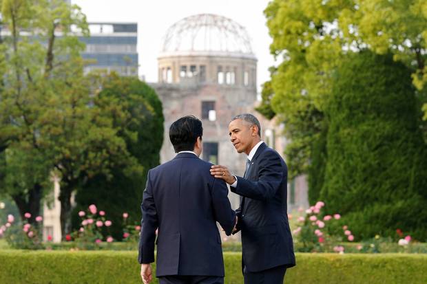 May 27, 2016: U.S. president Barack Obama puts his arm around Japanese Prime Minister Shinzo Abe after they laid wreaths in front of a cenotaph at Hiroshima Peace Memorial Park.