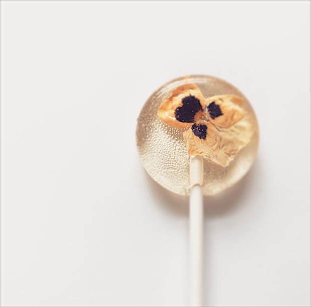 Some lollipops have sprinkles or edible flowers – tiny pansies and daisies – suspended in the clear candy.