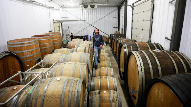 Vigneron François Morissette of the Pearl Morissette winery walks atop his French oak barrels while his wine slowly ages in October.