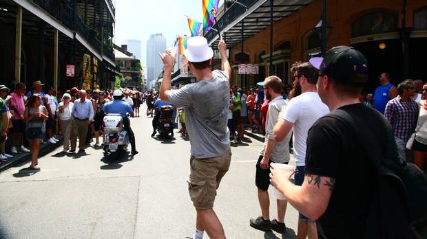 We organized a legal parade on the streets of New Orleans for a bachelor party. Chris, the groom in a top hat, led the way with a plastic baton. Behind us, a five-man brass band announced our presence and a police escort cleared the way.
