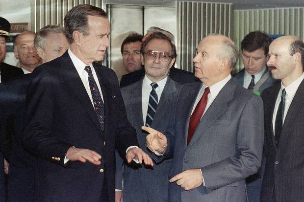 U.S. president George H. Bush, left, and Soviet president Mikhail Gorbachev, right, speak after Mr. Bush arrived on the Soviet cruise liner Maxim Gorky in Malta on Dec. 3, 1989.