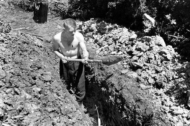 Summer, 1944: Jack Ford digs a trench the morning after an air raid on his first night in Normandy.